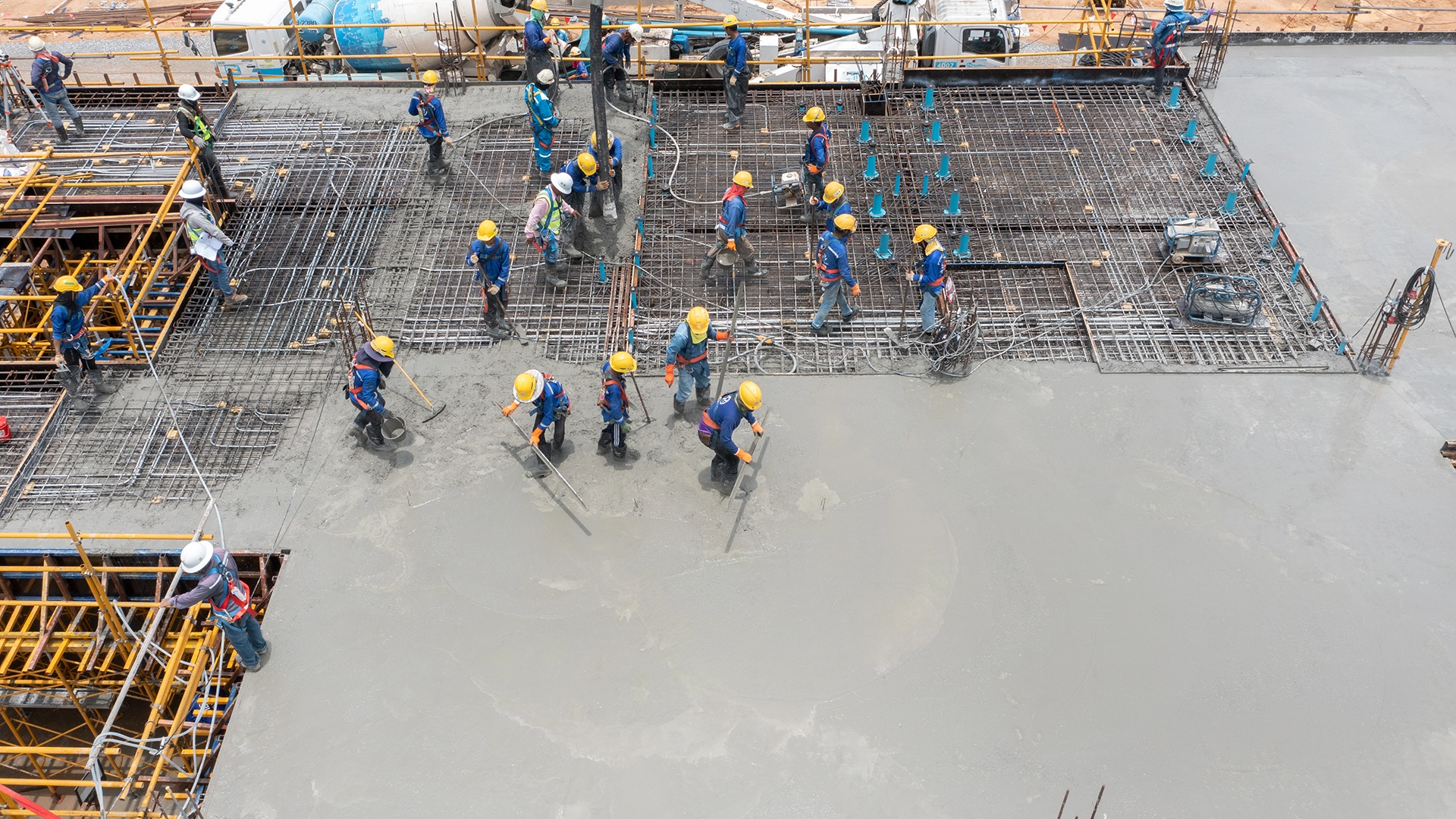 construction workers pouring concrete